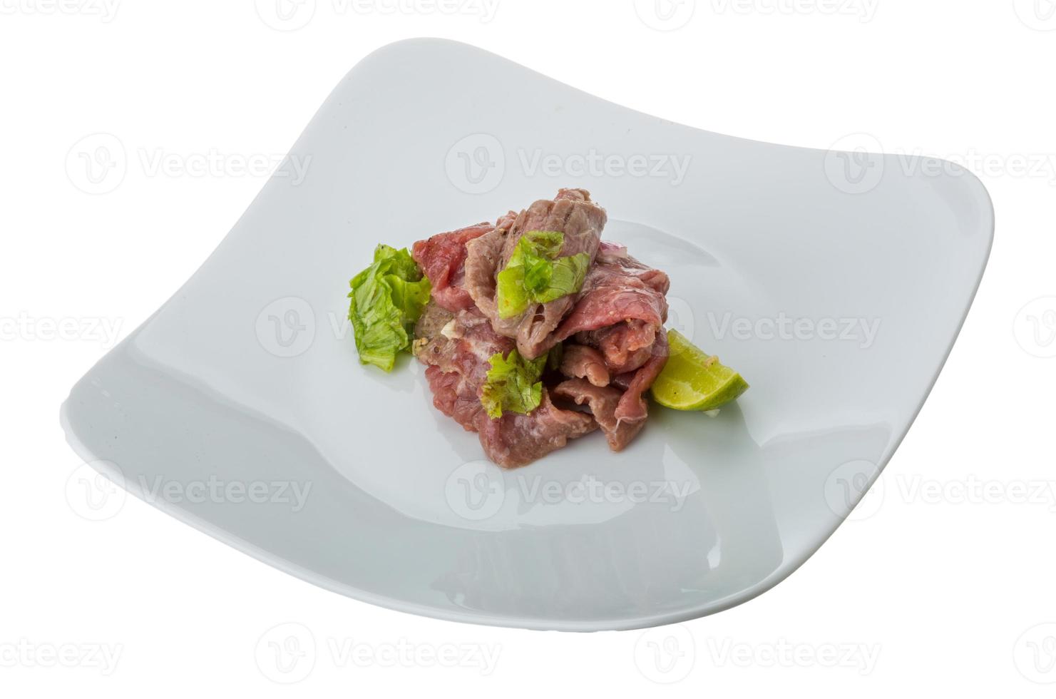 Beef carpaccio on the plate and white background photo