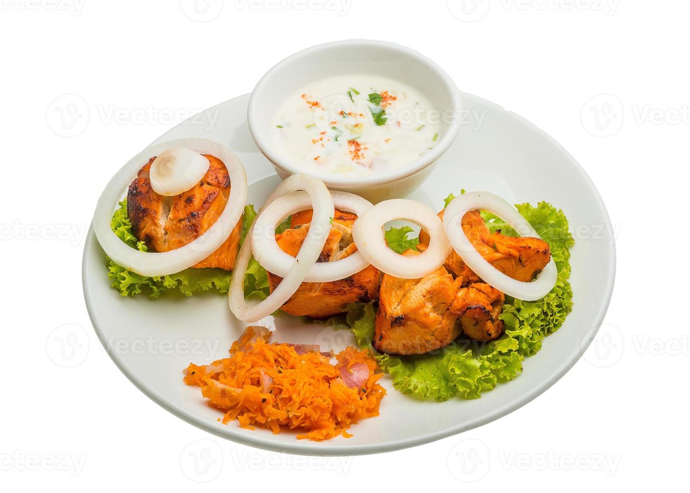 Chicken Tikka on the plate and white background photo