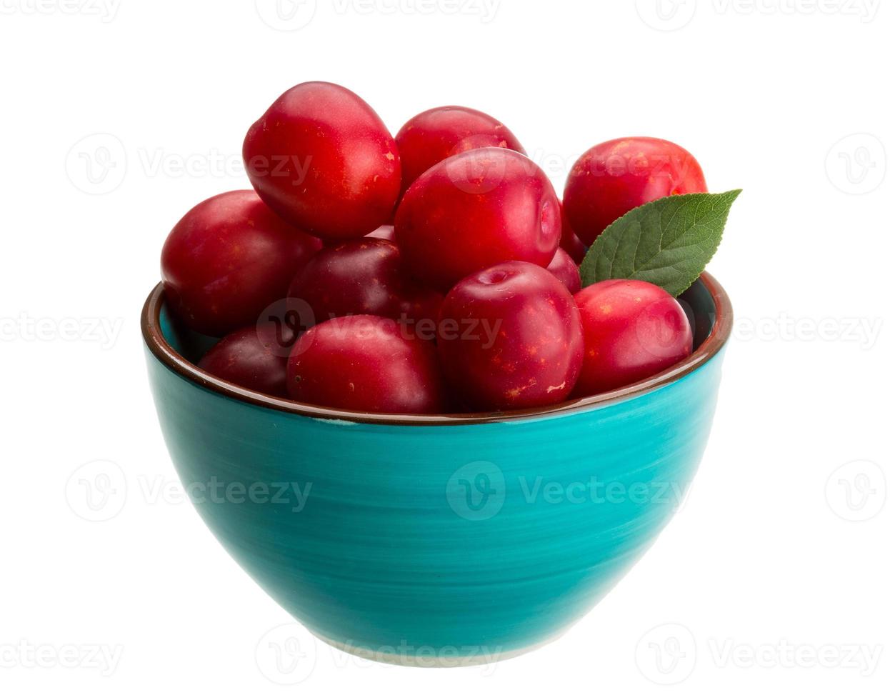 Damson plum in a bowl on white background photo