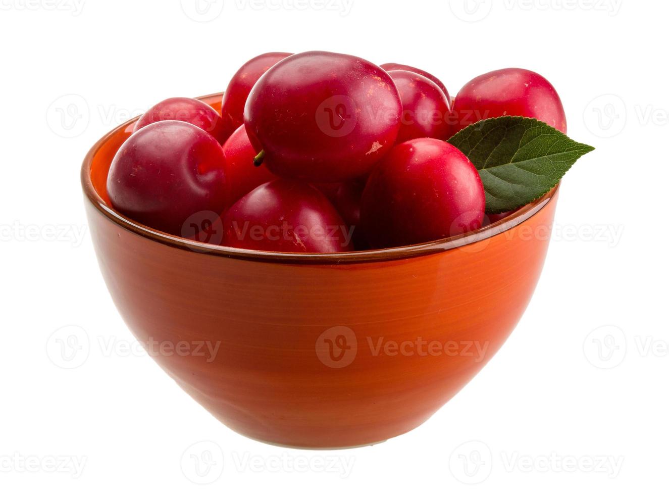 Damson plum in a bowl on white background photo