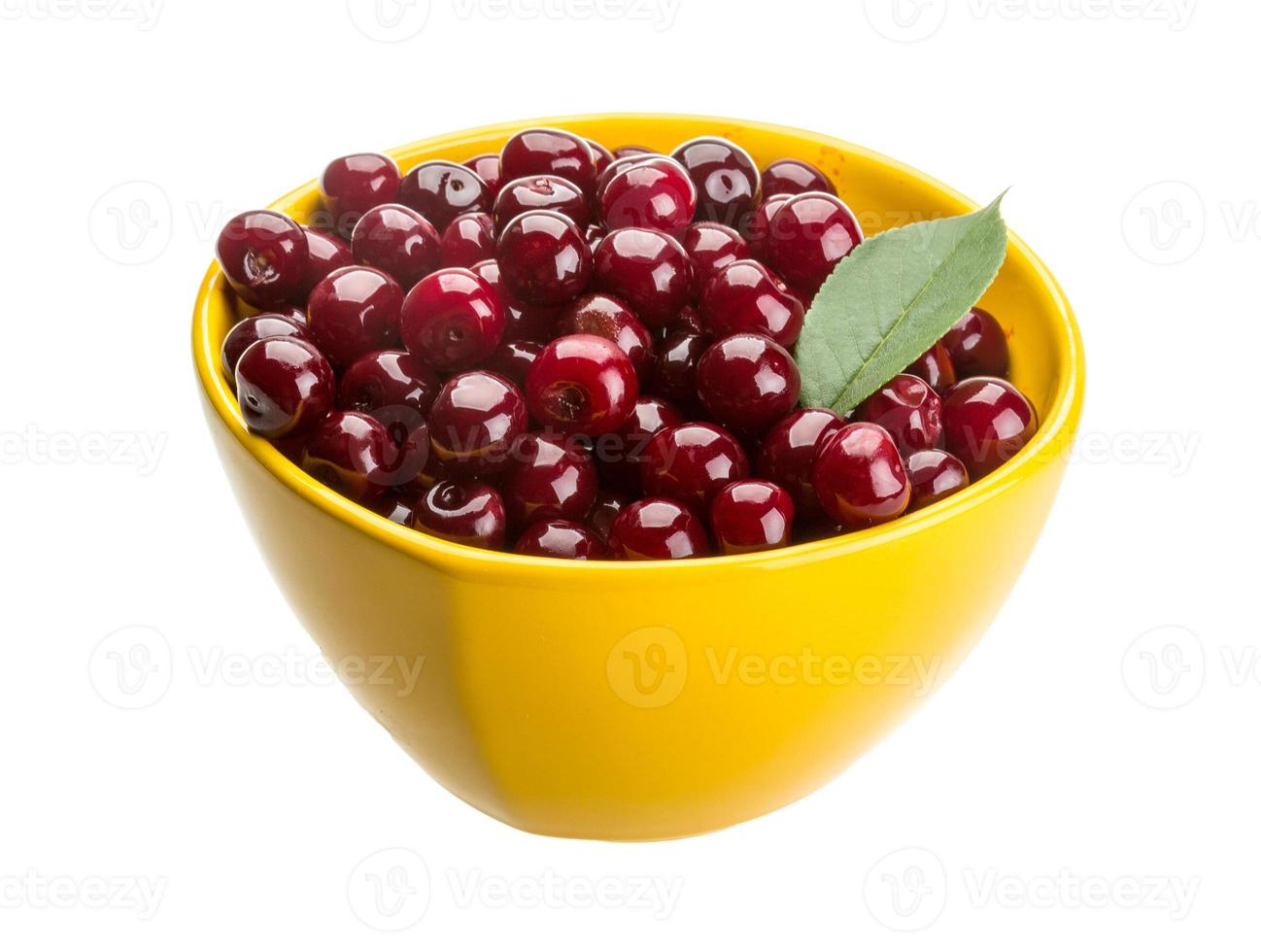 Cherry in the bowl on white background photo