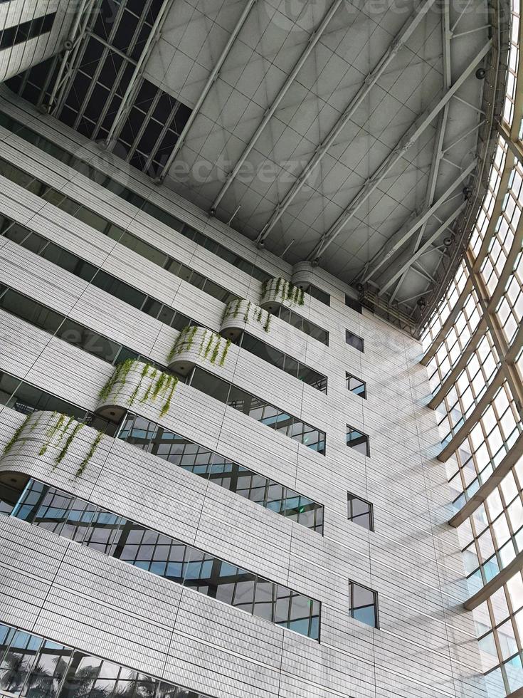 West Java, Indonesia on July 2022. The inside of a tall building, lots of glass and very futuristic. photo