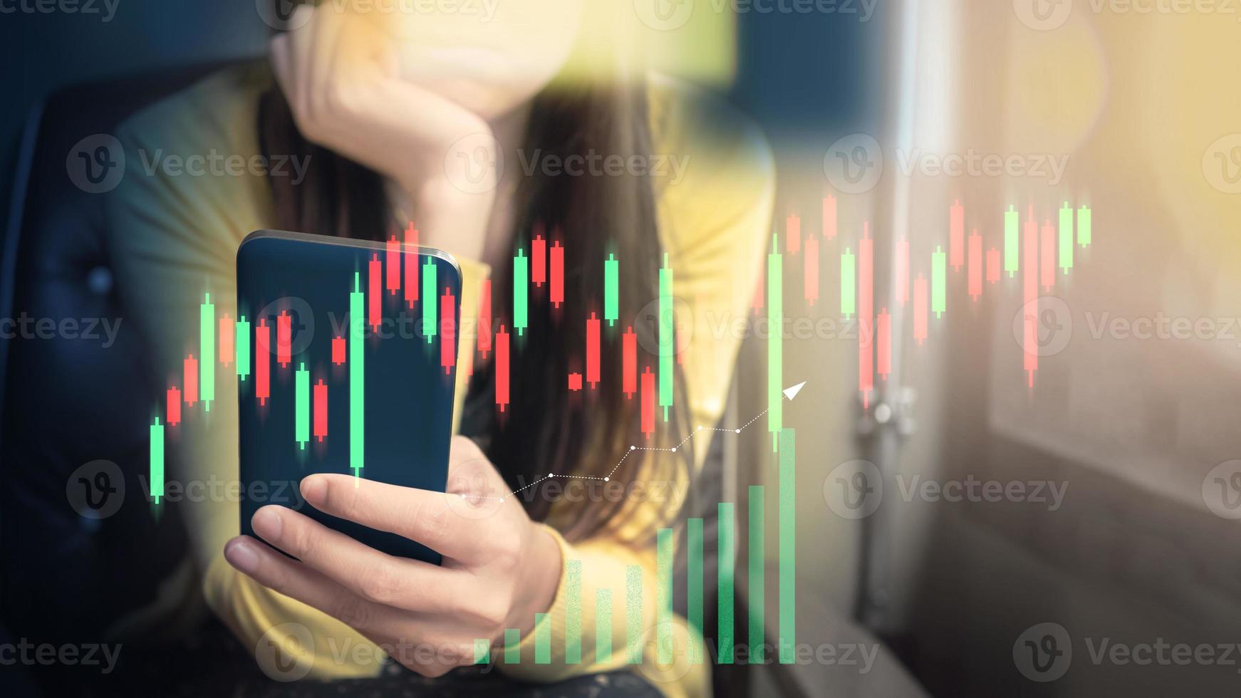Financial technology and investment ideas with stock markets and mutual funds. Woman analyzing financial data with graph trading from smartphone at home. photo