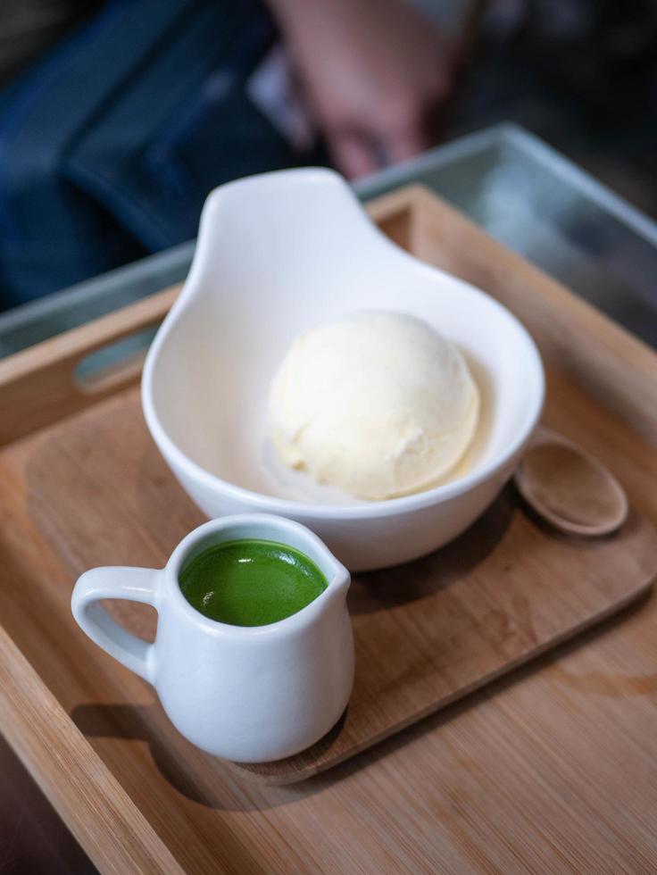 ice cream vanilla flavor with matcha green tea topping in a bowl cup in minimal japanese style cafe photo