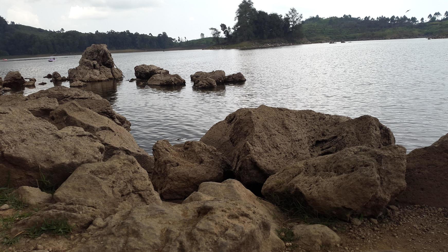 lake with rocks around it photo