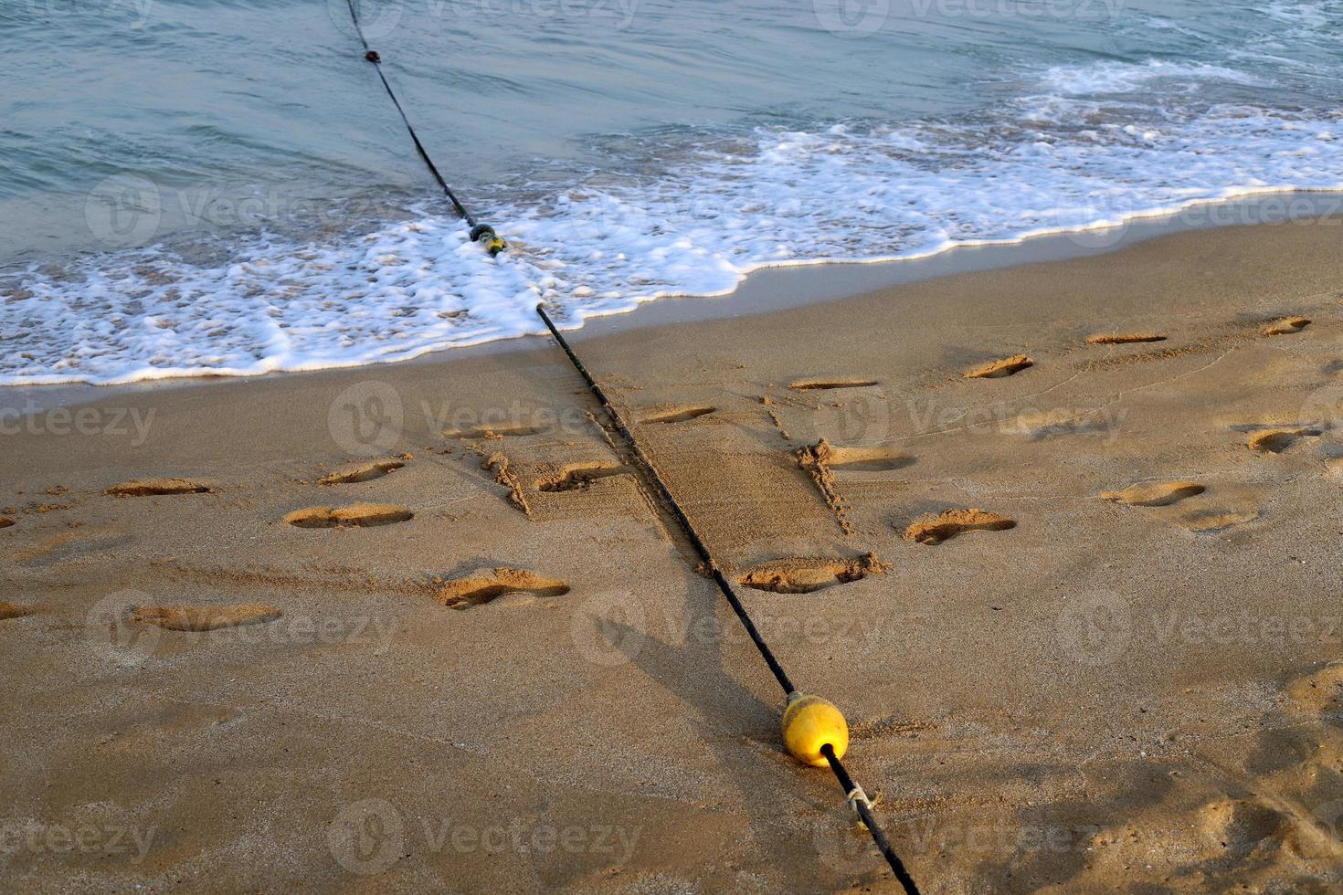 Footprints in the sand on the shores of the Mediterranean Sea. photo