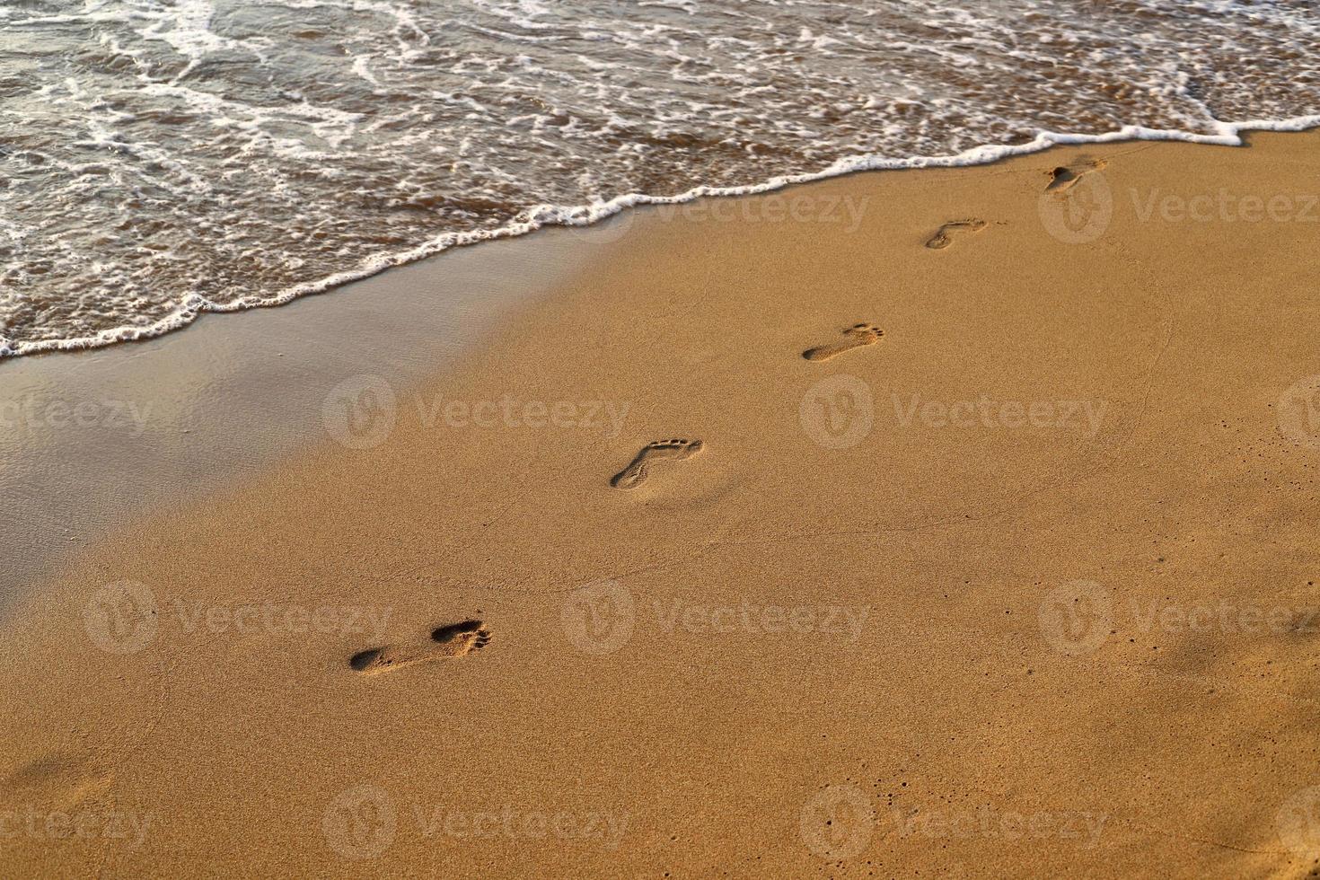 Footprints in the sand on the shores of the Mediterranean Sea. photo