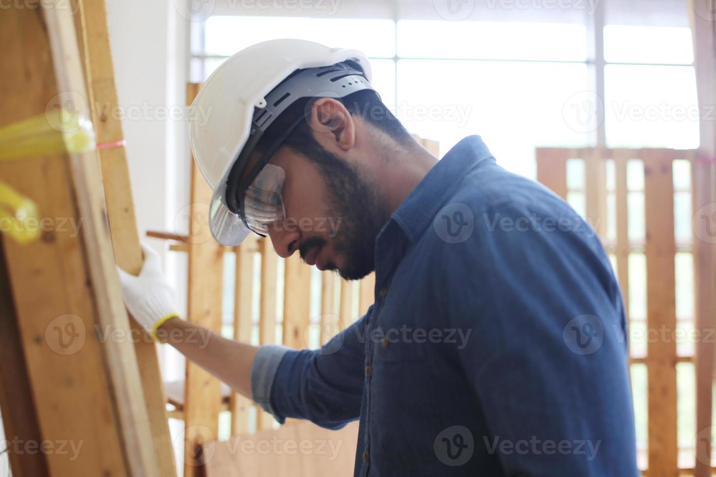 Carpenter grinding joinery product with carvings, finishing woodwork at the carpentry manufacturing photo