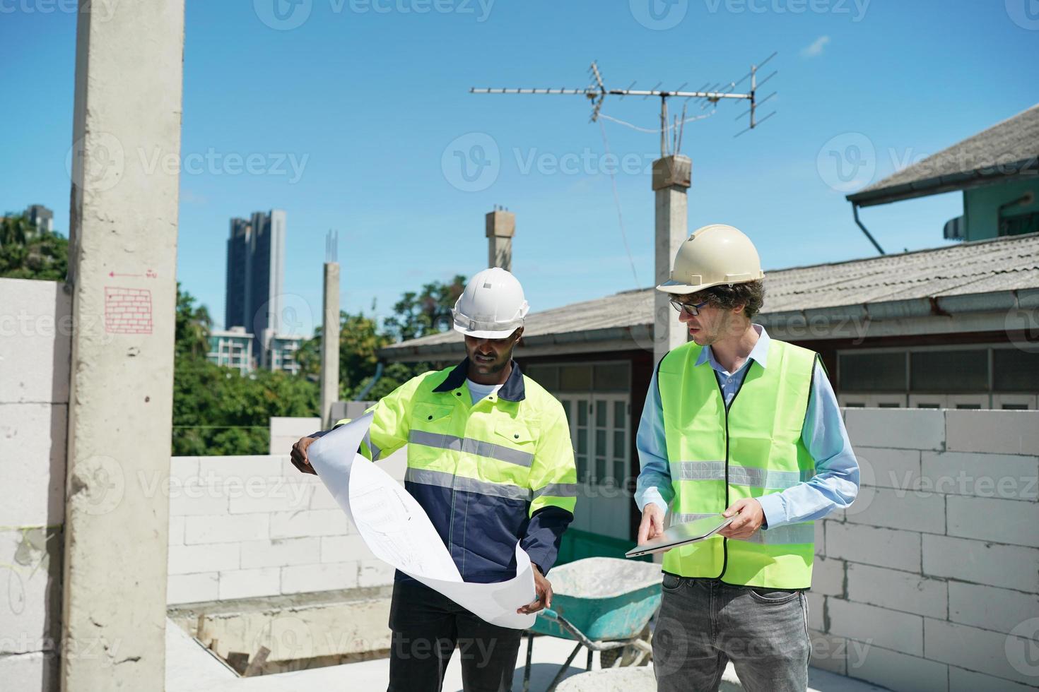 Architect and construction engineer or surveyor discussion plans and blueprints photo