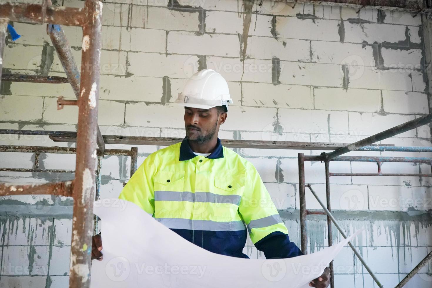 Architect and construction engineer or surveyor discussion plans and blueprints photo