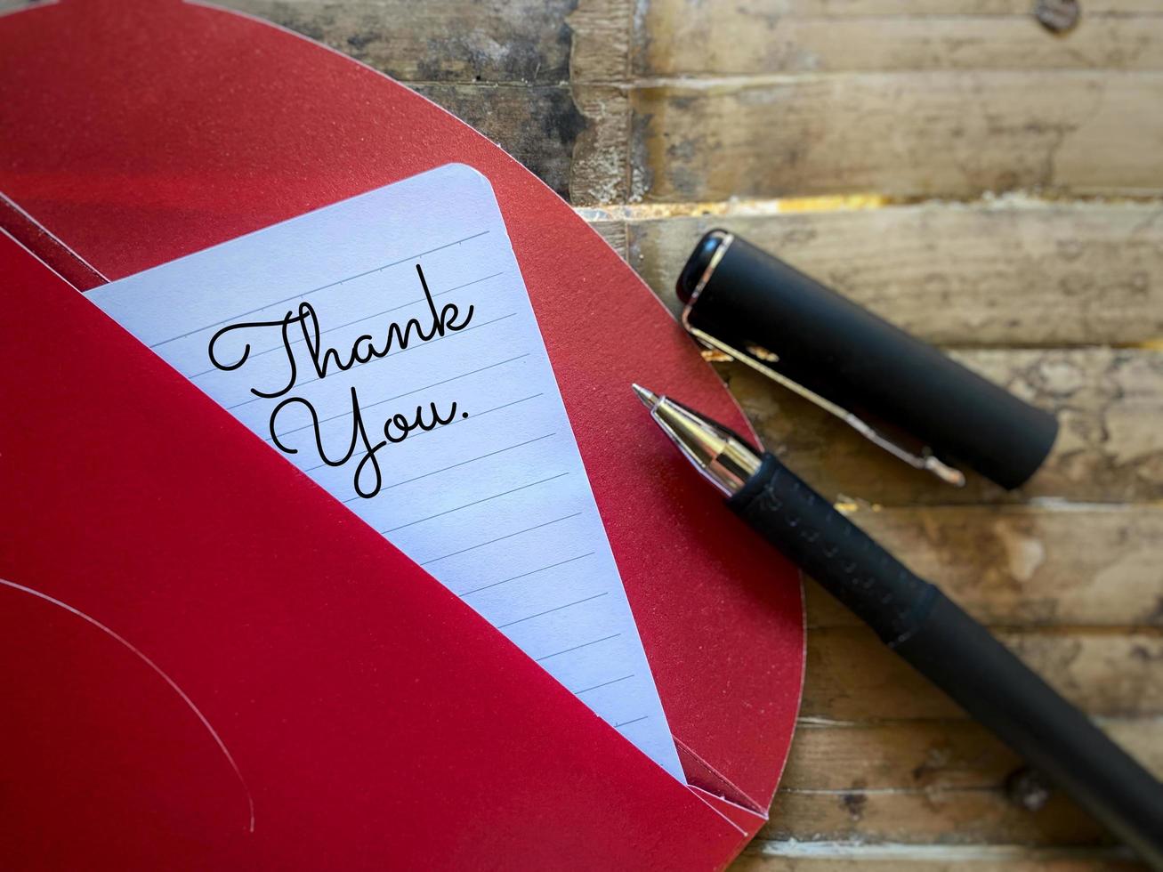 Thank you sign written on white paper. Stock photo. photo