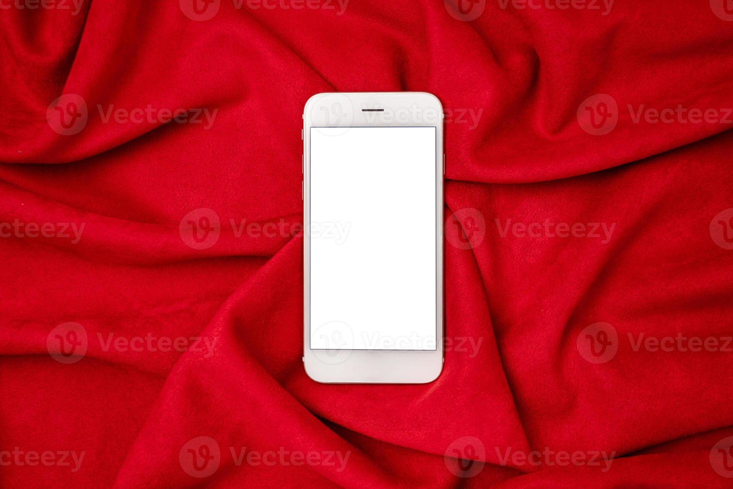 Black mock up mobile phone on red fabric background. Mobile app mockup