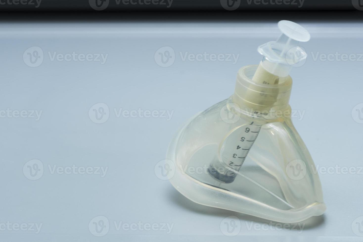 Ambu mask and syringe on the desk photo