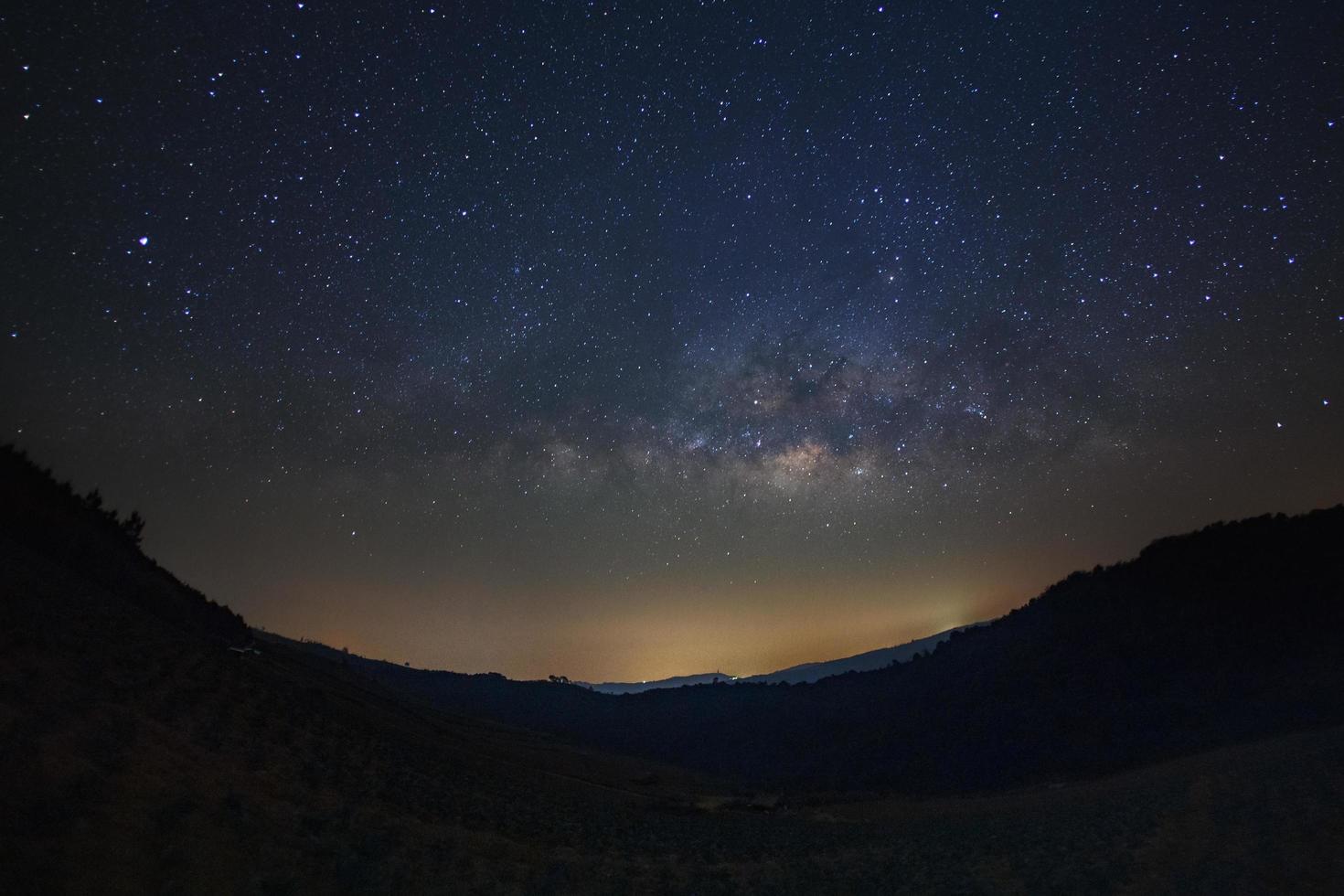 Milky Way and silhouette of tree at Phu Hin Rong Kla National Park,Phitsanulok Thailand, Long exposure photograph.with grain photo