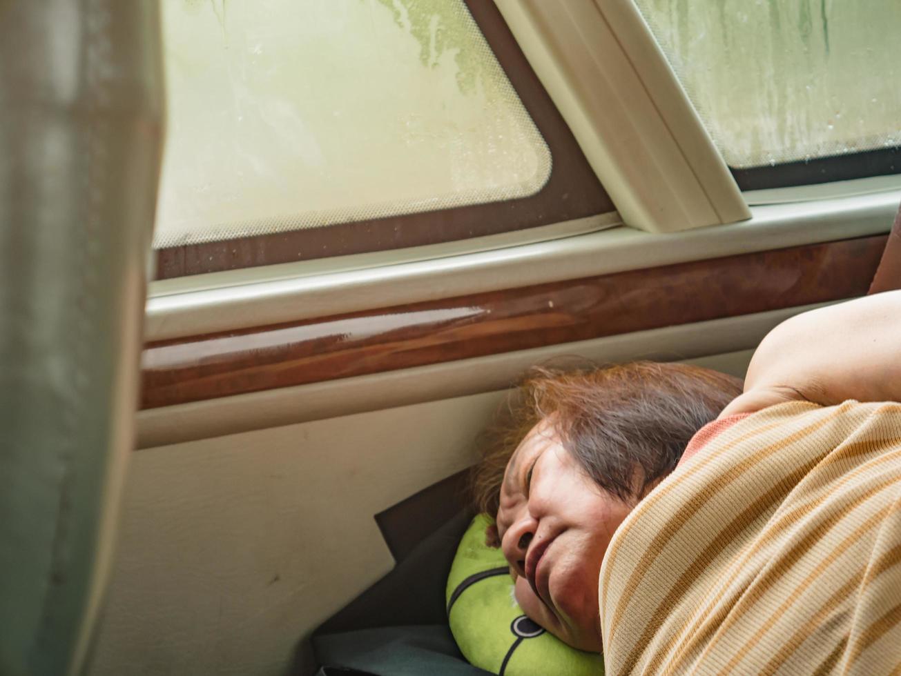 Portrait Photo of Senior asian womam Sleep on the Bus when her vacation.