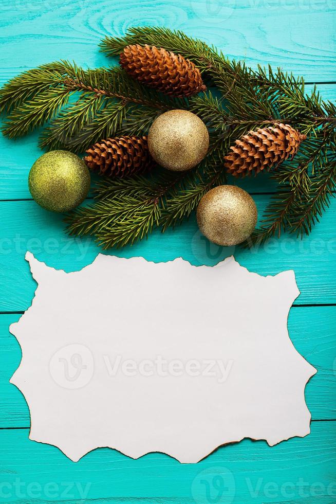 Frame of pine cones on a Christmas tree on blue wooden background. Top view photo