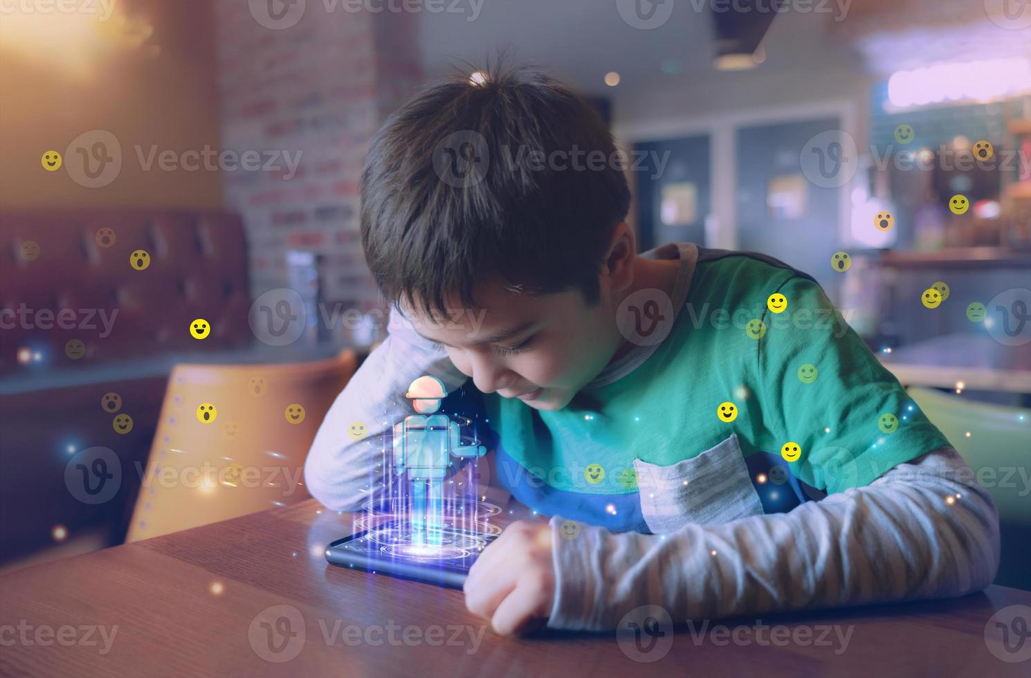 Kid building robot game on mobile phone with notification face icon pop up,Boy programming Robot with double exposure of screen web surfing,cyber diagram interface,Education technology,Online learning photo