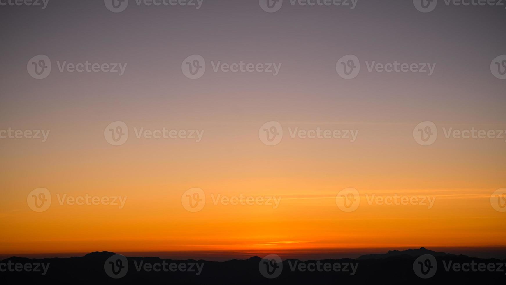 Beautiful bright cloud sky with light for heaven religion background. Sunrise and twilight or sunset cloudscape is orange and blue colours in summer nature. photo