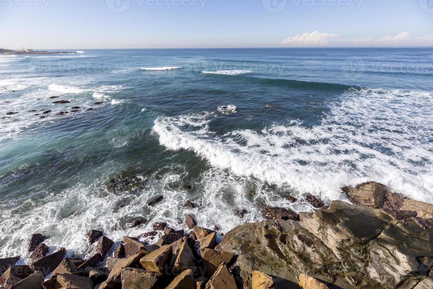 Seascape with rocks in the foreground photo