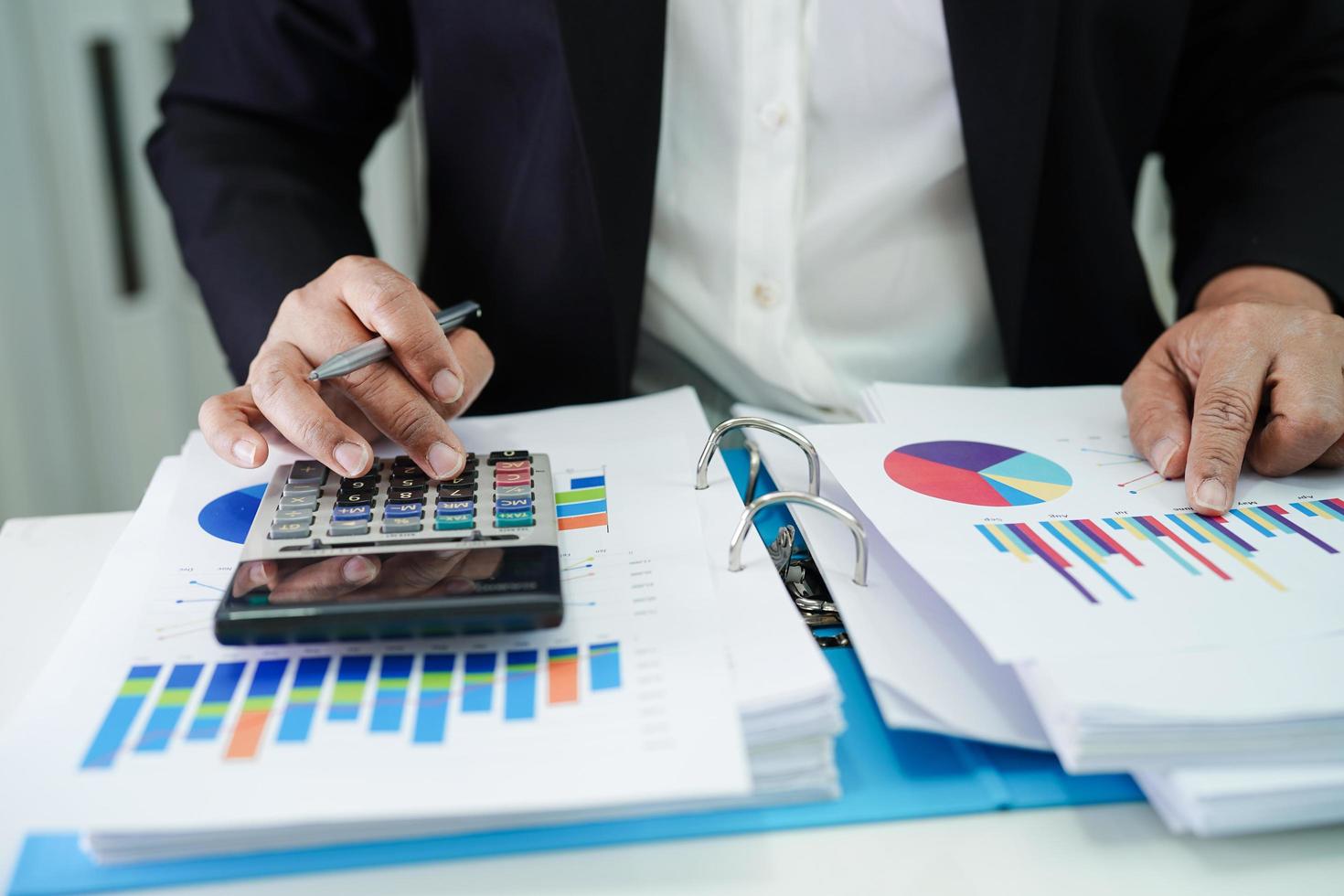 Business woman working and analysis with statistic graph in office. photo
