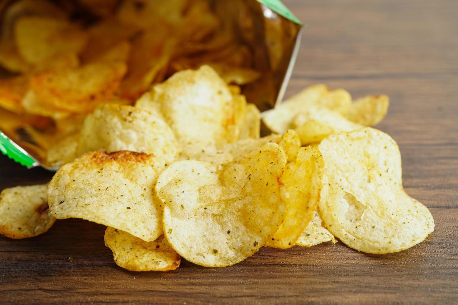 Potato chips in open bag, delicious BBQ seasoning spicy for crips, thin slice deep fried snack fast food in open bag. photo