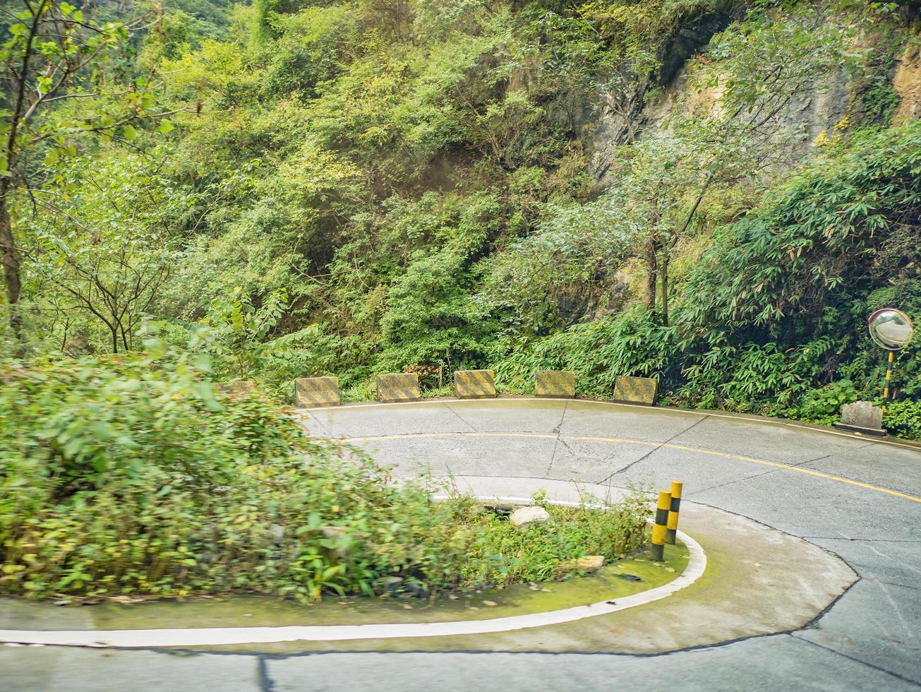 Sharp curve view on the bus on tongtian road moving from tianmen mountain heaven gate cave on tianmen mountain national park at zhangjiajie city China.Tongtian Road the winding Road  99  curves road photo