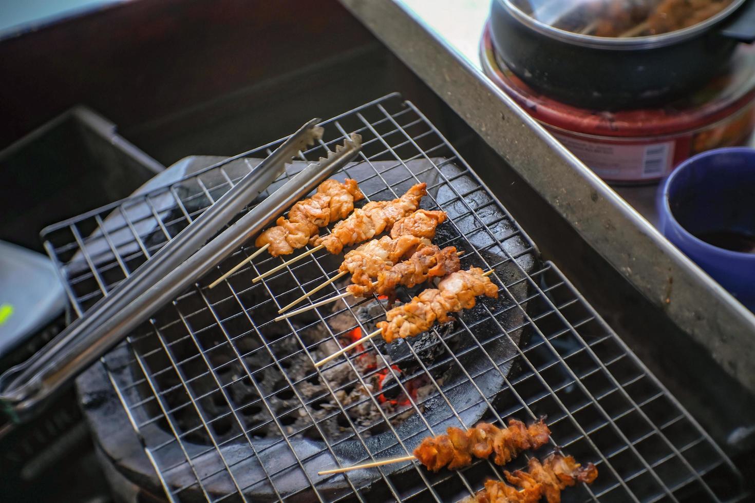 Selling Grilled crocodile Stick shop on the boat in Pattaya Floating Market in Chonburi City Thailand .Pattaya Floating Market is the Famous Floating Market near Pattaya and very Popular for Tourist photo