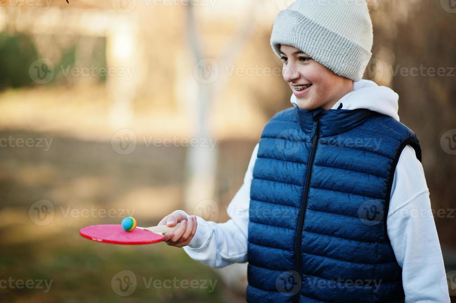 Boy play hold ball on the racket. photo
