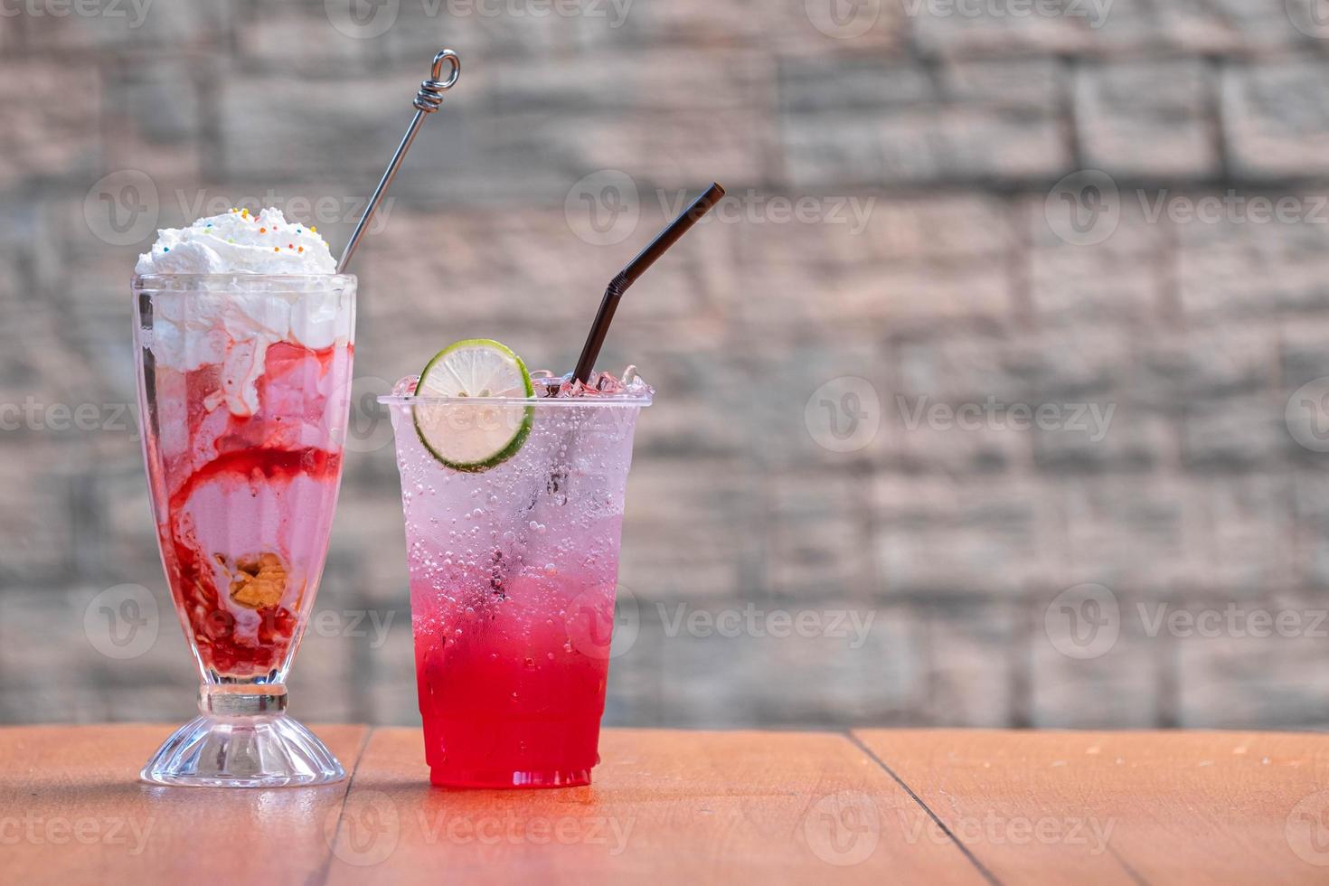 The red juice, soda Red water-lemon soda whit lemon slide and Strawberry Ice Cream whit cream topping on wood table and blurred background photo