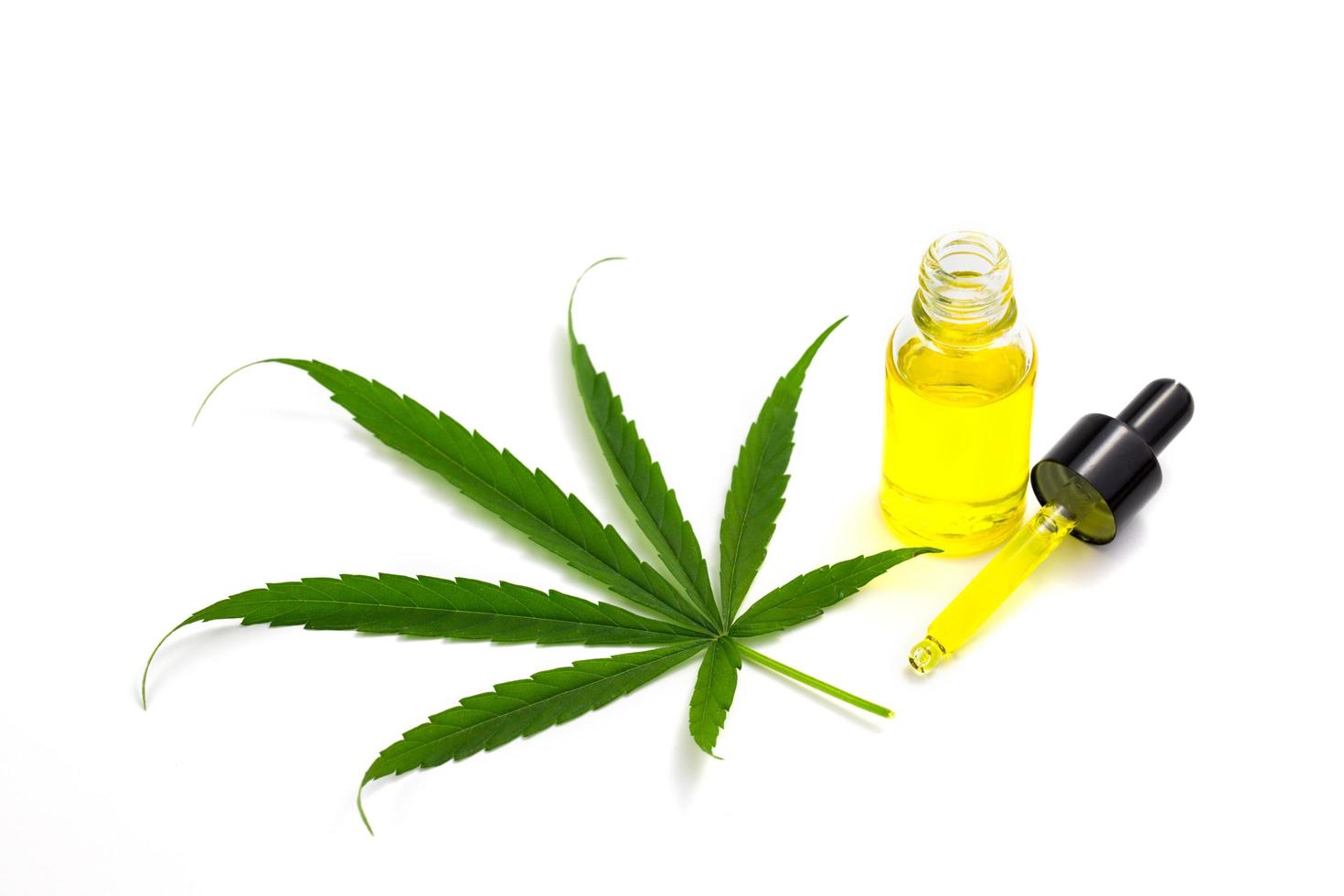 CBD hemp oil, Hemp oil extract in glass bottles , medical marijuana concept, on a white background, CBD oil pipette. photo