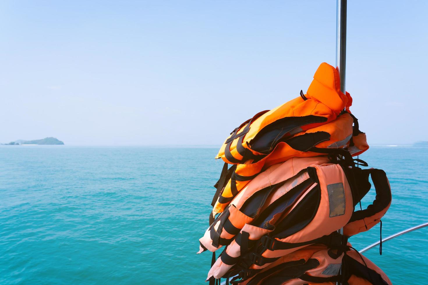 Stack of life jackets for boat Sea sailing wearing diving suit swim . photo