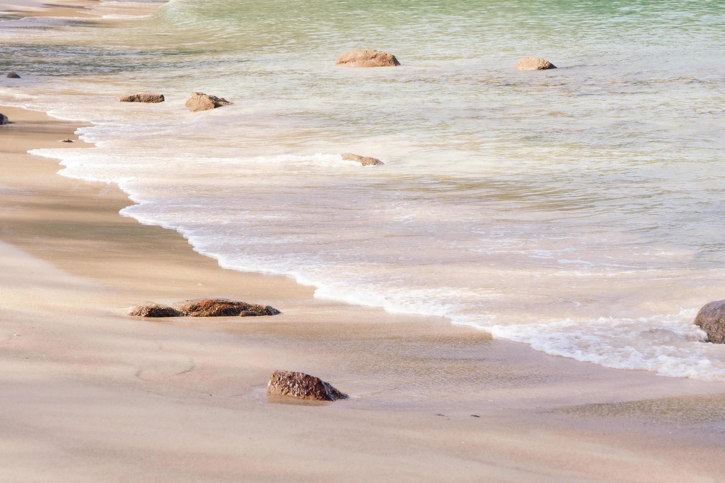 Close up. Waves sea texture lapping across untouched shore. photo