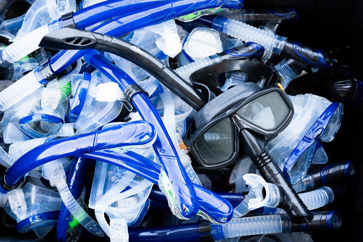 Blue mask snorkel scuba diving goggles at sea. photo