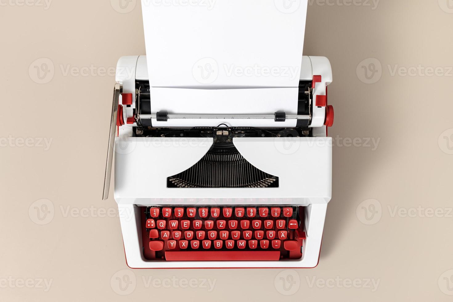 Top view of a retro typewriter with blank white paper. Creative writing process concept photo