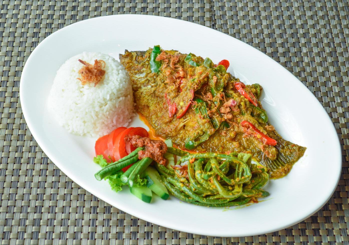 Bali, Indonesia, 2018 - Gurame Nyat-nyat a Balinese fried gurame served with rice and vegetables photo