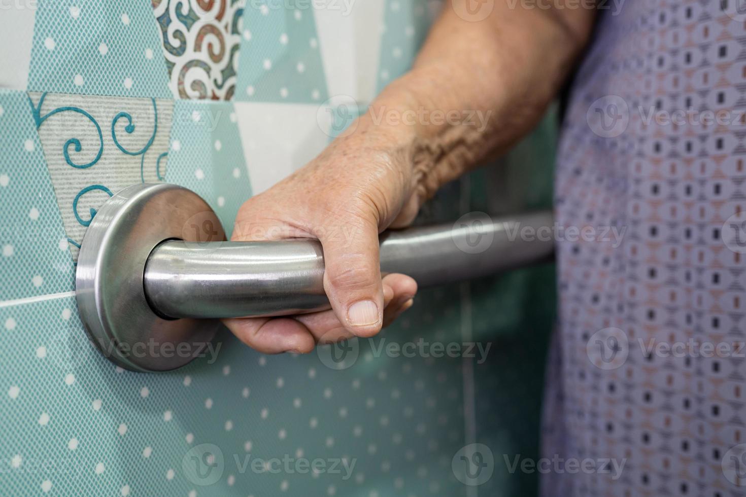 Asian senior or elderly old lady woman patient use toilet bathroom handle security in nursing hospital ward, healthy strong medical concept. photo