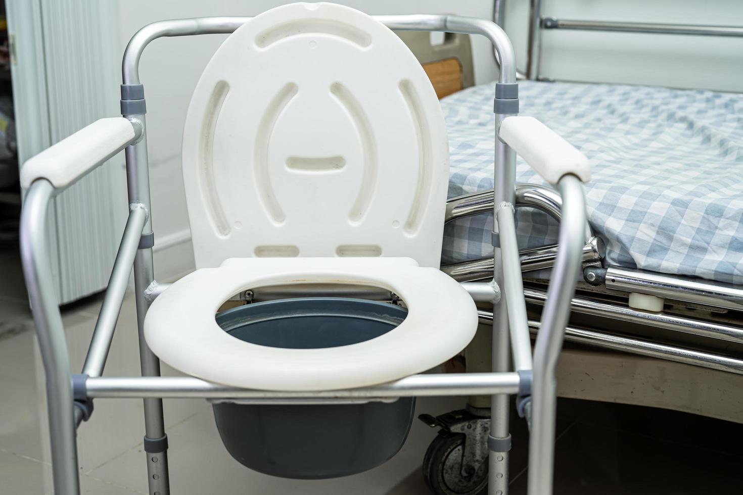 Flush toilet and shower chair in bathroom for old elder people. photo