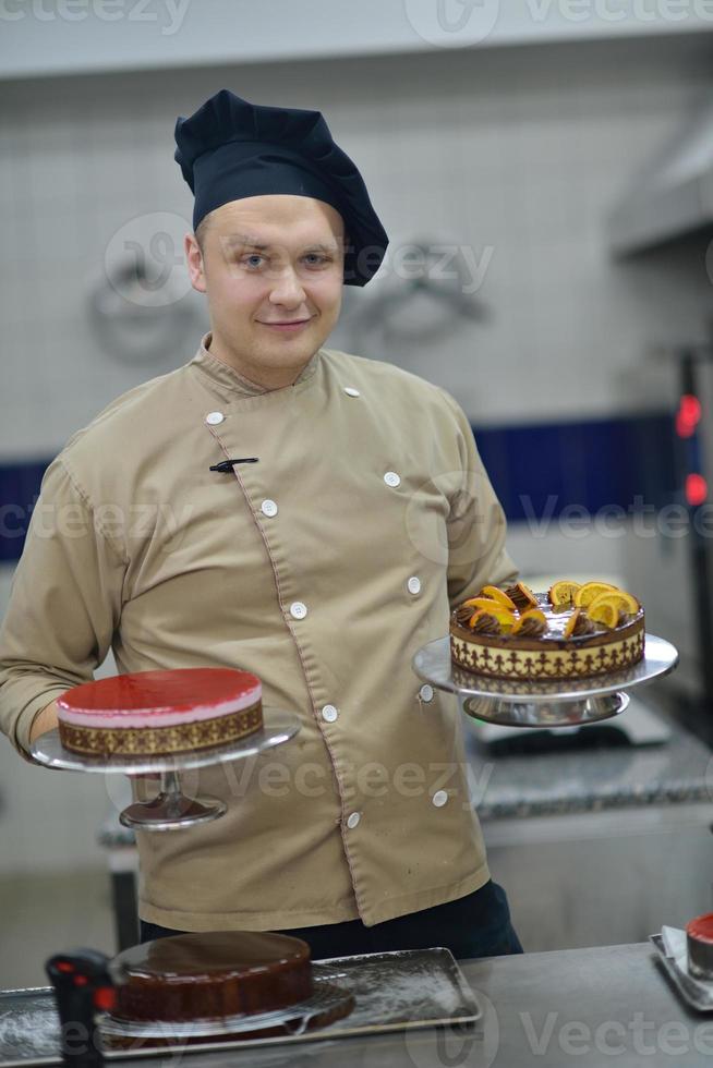 chef preparing desert cake in the kitchen photo