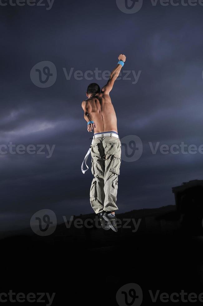 young man dancing and jumping photo