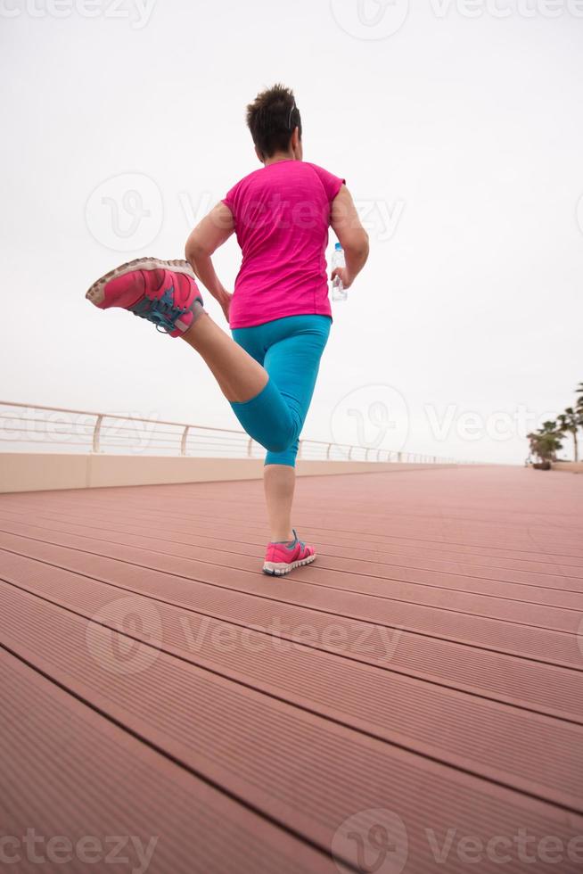 woman busy running on the promenade photo