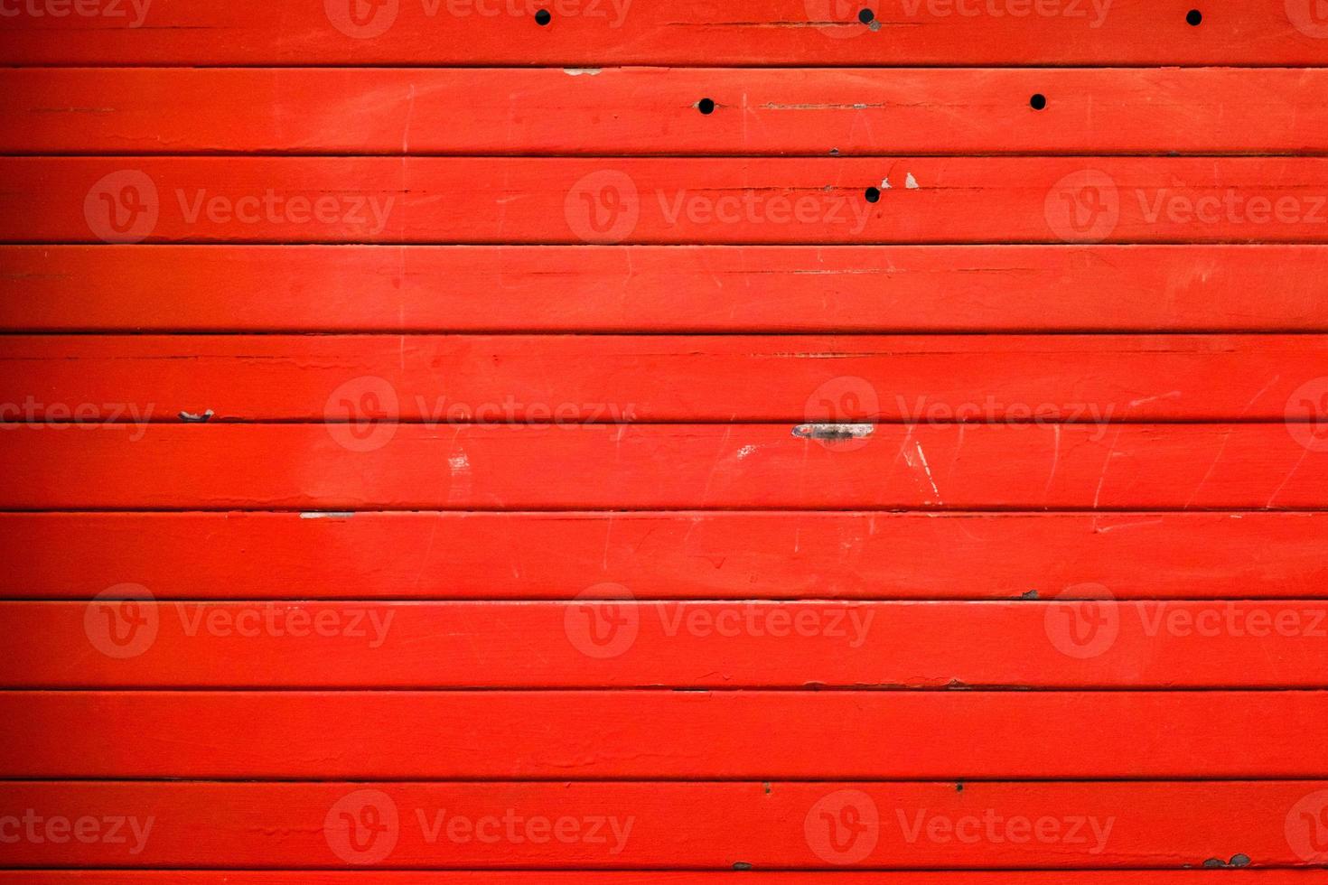 Striped metal textured wall painted in a red, background, abstract horizontal lines, dirty steel colored shutter garage door, grunge texture and pattern. photo