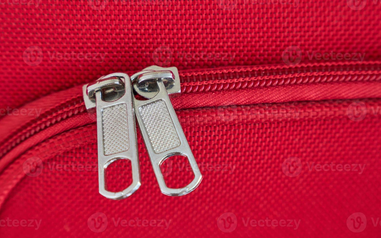 zip close-up on a tourist red suitcase photo