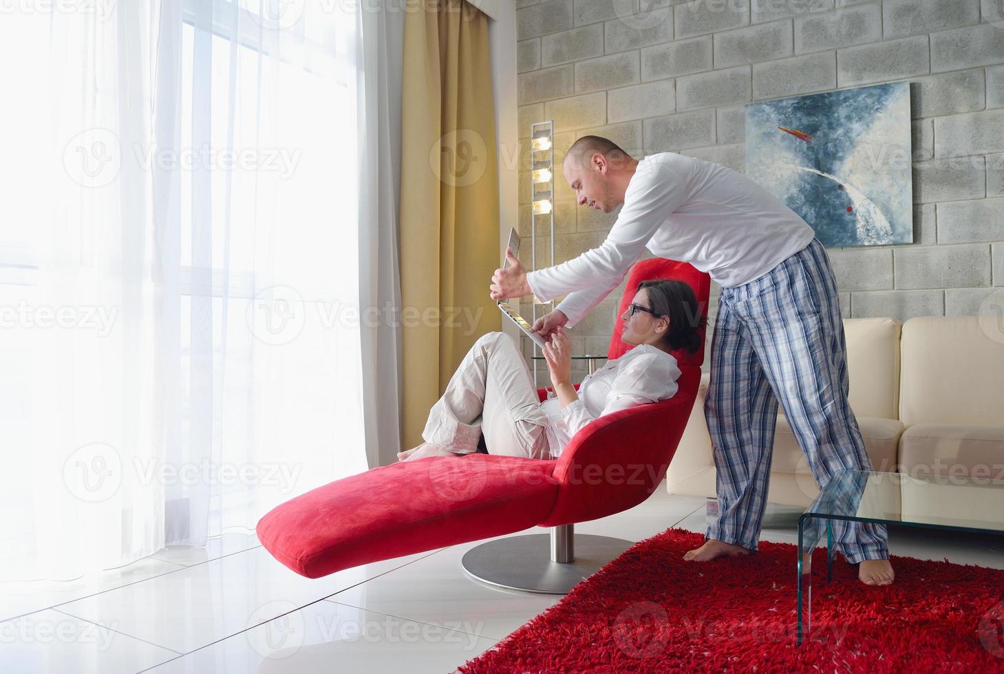 young couple using Laptop computer at home photo