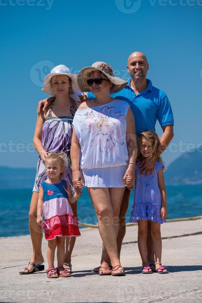 Portrait of happy multi generation family by the sea photo