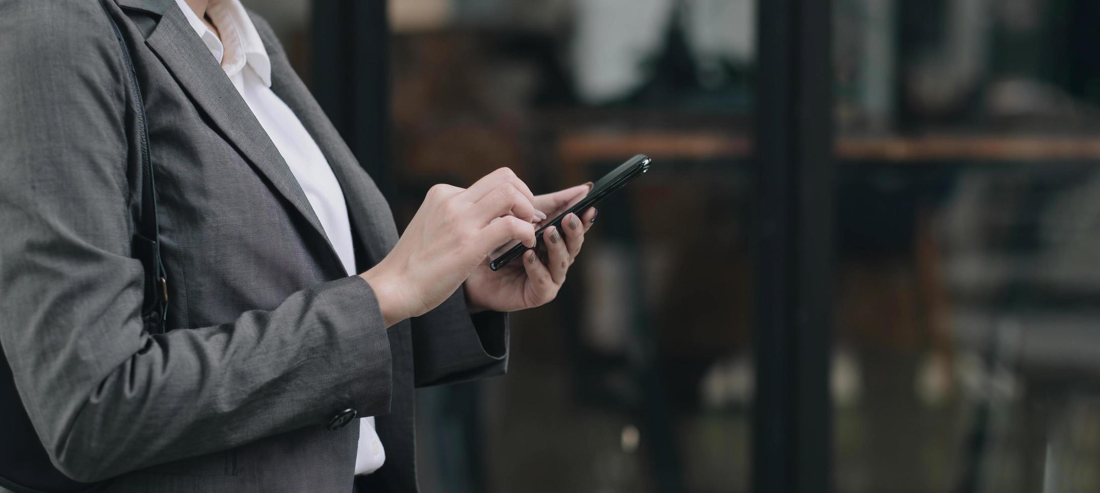 woman using apps on a mobile touchscreen smartphone. Concept for using technology, shopping online, mobile apps, texting, addiction, swipe up, swipe down. photo