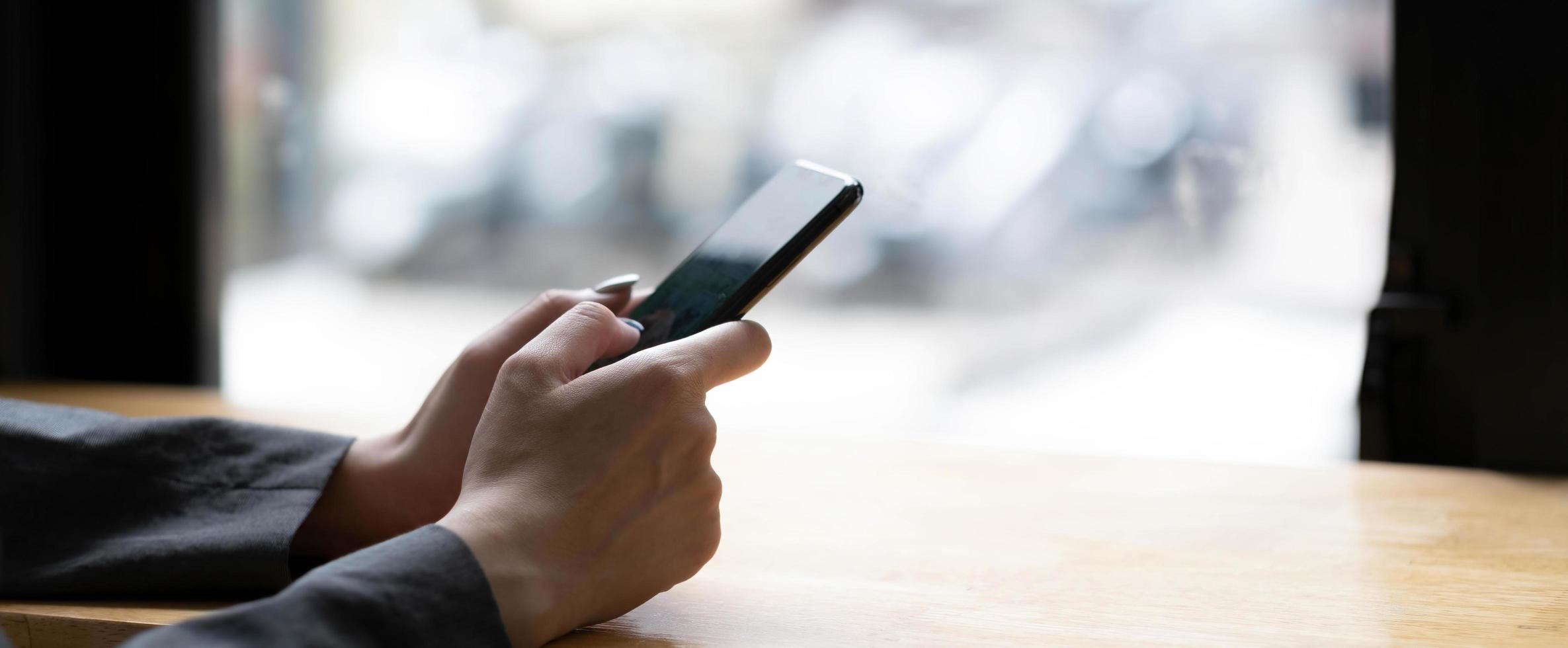 woman using apps on a mobile touchscreen smartphone. Concept for using technology, shopping online, mobile apps, texting, addiction, swipe up, swipe down. photo