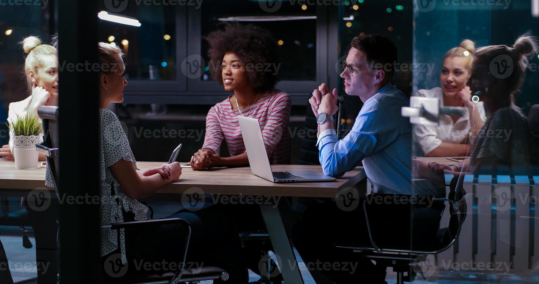 Multiethnic startup business team in night office photo