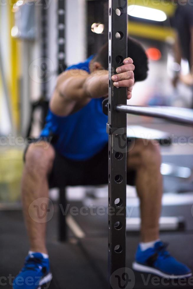 man doing pull ups on the vertical bar photo