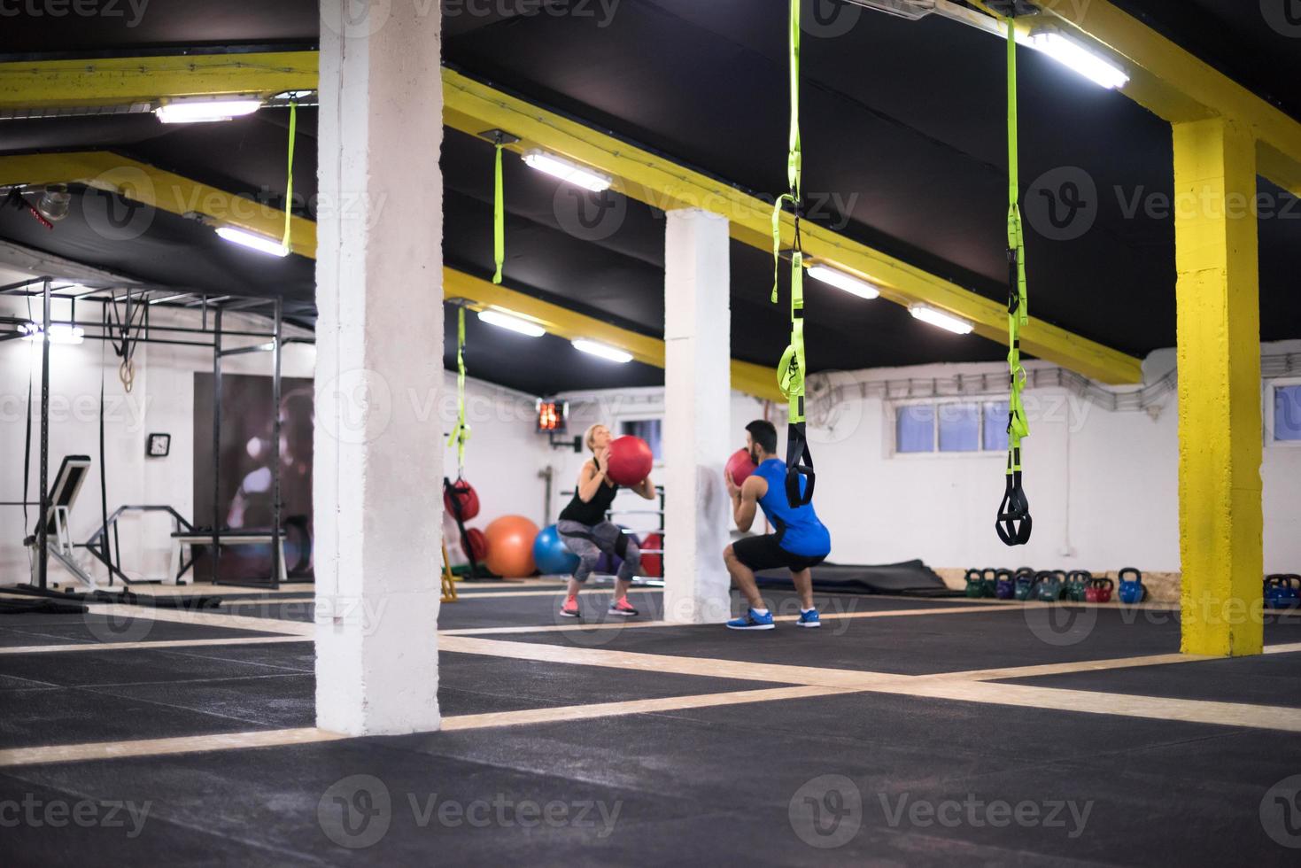 young athletes couple working out with medical ball photo