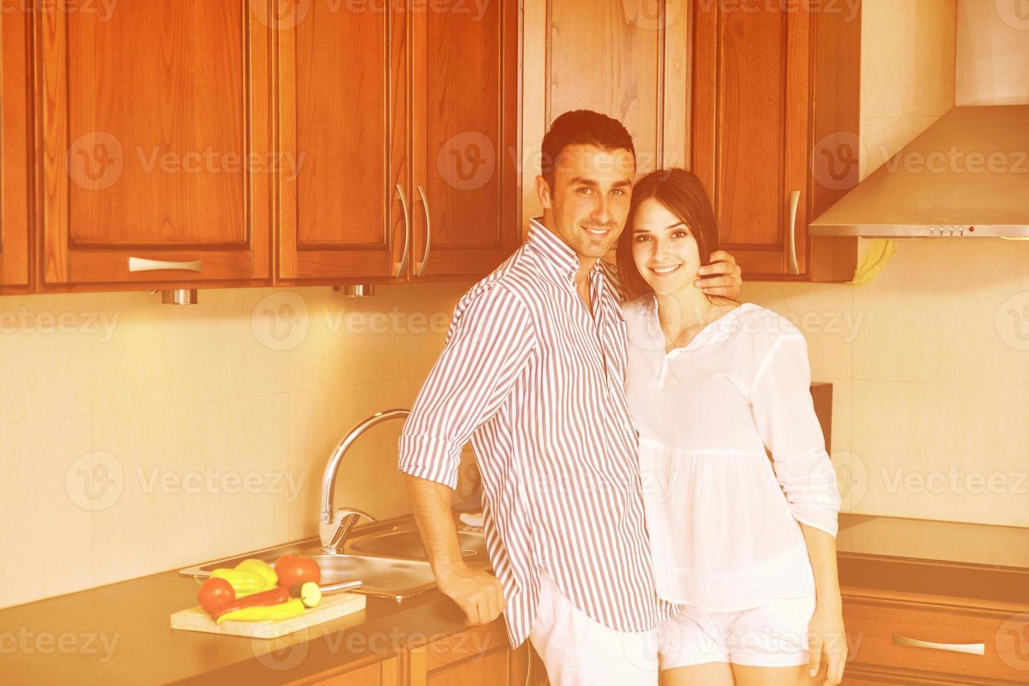 happy young couple have fun in modern kitchen photo